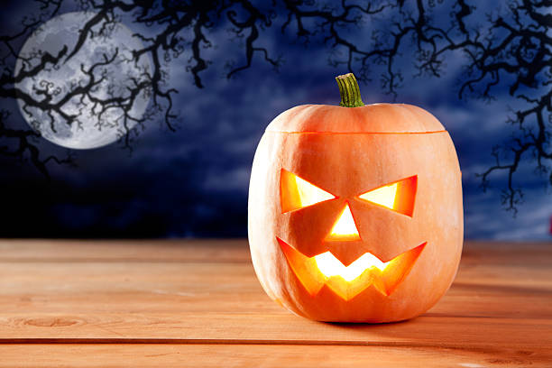 istock halloween lantern pumpkin  in dark sky clouds 176878492
