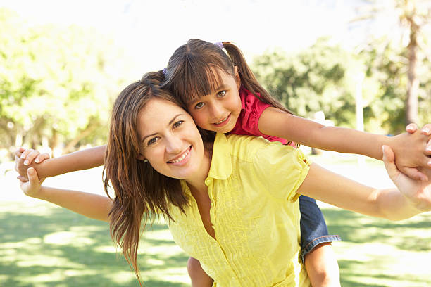 istock Mother Giving Daughter Ride On Back In Park 176878570