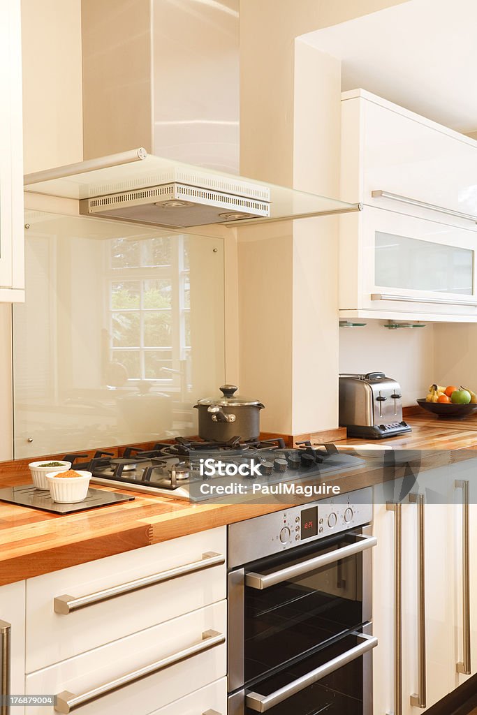 Kitchen closeup "Modern white kitchen with stainless steel cooker, gas hob and chimney extractorSimilar images from my portfolio:" Splash Back Stock Photo
