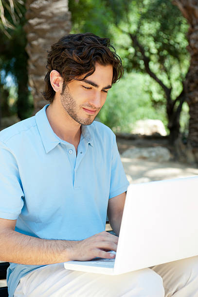 istock Portrait of a young man with laptop 176879123