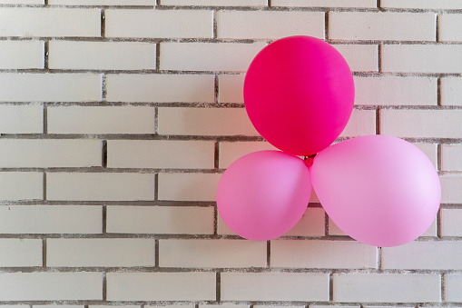 festive red balloons on a brick wall background. Concept holiday birthday. copy space. Valentine's day background