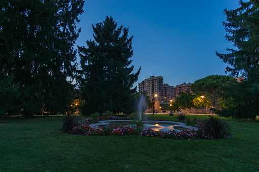 Fountain with water on park meadow in citadel at night during blue hour in Pamplona, Navarra, Spain