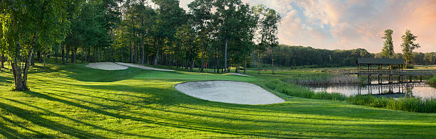 Panoramic view of golf green with white sand traps
