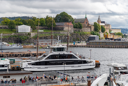 A picture of the Oslofjord Ferry and the Akershus Fortress.