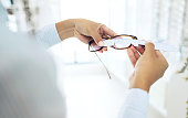 Eye care, hands measure lens and frame of glasses, person in optometry clinic with test and healthcare. Eyewear, wellness and prescription with health, spectacles and optometrist with ruler tools
