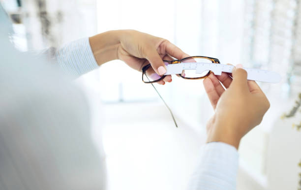 eye care, hands measure lens and frame of glasses, person in optometry clinic with test and healthcare. eyewear, wellness and prescription with health, spectacles and optometrist with ruler tools - human eye eyesight optometrist lens imagens e fotografias de stock