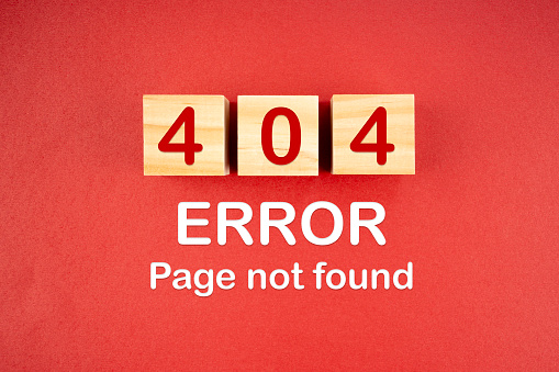 Wooden cubes with 404 error page not found on red background.