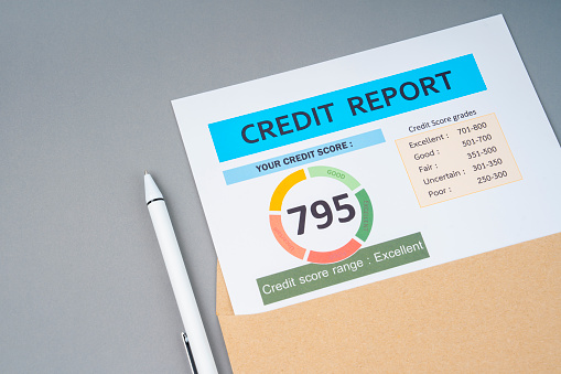 Close-up of credit report with pen on gray color background.