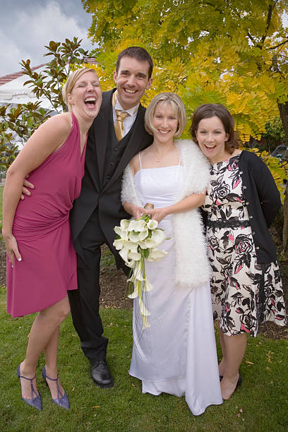 istock Wedding Fun Bride Groom and Two Guests Laughing 176879988