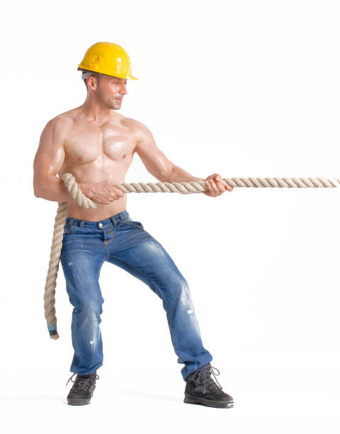 Pulling Works 720+ Construction Worker Pulling Stock Photos, Pictures & Royalty-Free ...