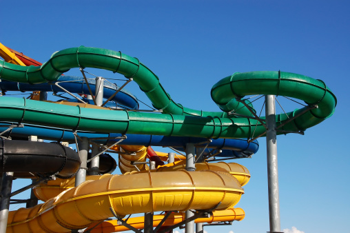 Multi-colored pipes of an aquapark against the blue sky.