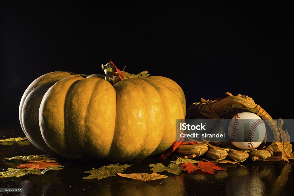 October Classic A studio shot of a pumpkin and a baseball glove and ball with fall leaves. Baseball - Ball Stock Photo