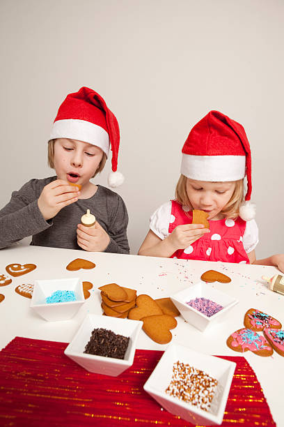 istock Girls decorating gingerbread cookies 176881058