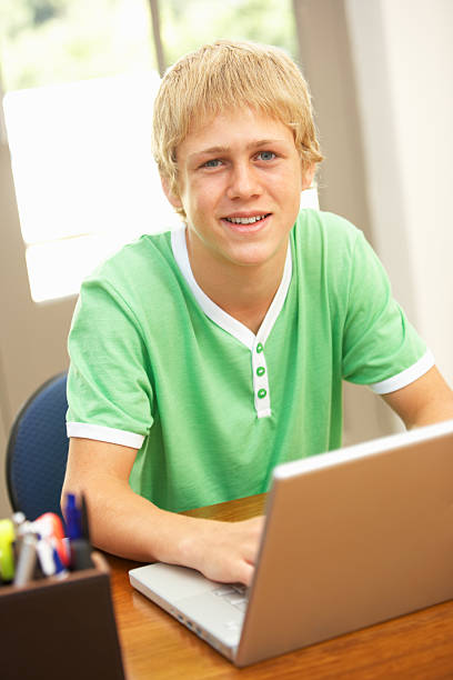 istock Teenage Boy Using Laptop At Home 176881268