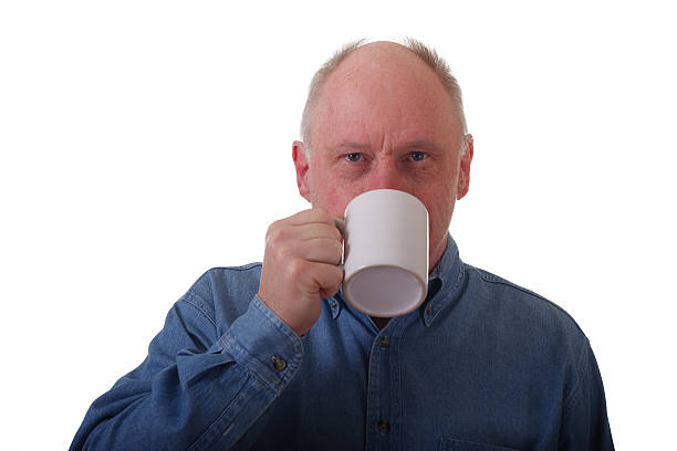 istock Older Balding Man in Blue Shirt Drinking Coffee 176882033