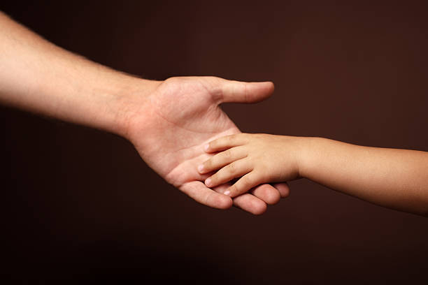 parent's love father's and son's hands. soft focus kid holding fathers hand stock pictures, royalty-free photos & images
