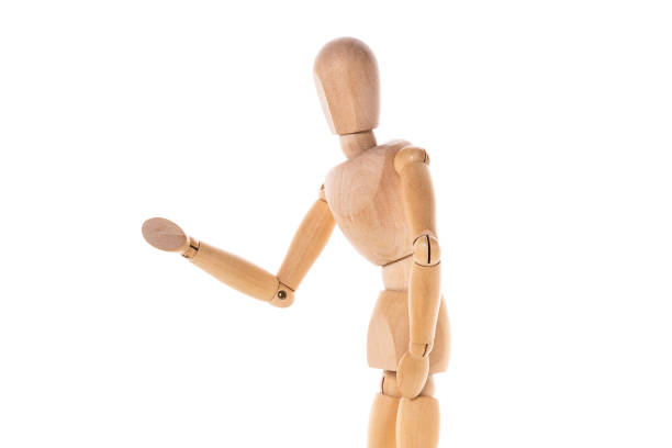istock A wooden mannequin standing in front of a white background. This versatile image can be used for various purposes. 1768838896