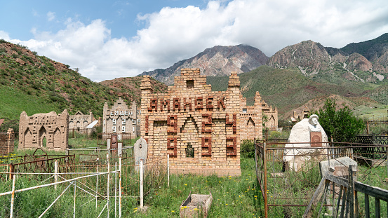 Osh, Kyrgyzstan - May 2022: A Kyrgyz grave in a traditional muslim cemetery