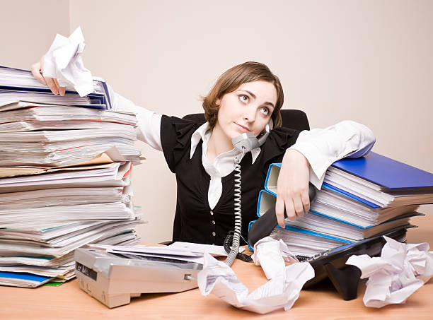 istock Young businesswoman with tons of documents 176884143