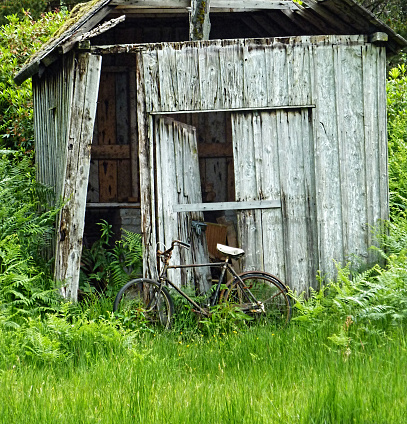 Bicycle Leaning Against a ramshackle Shed