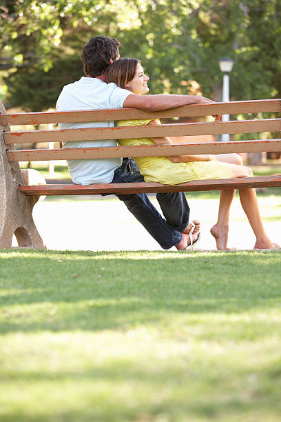 istock Couple Sitting Together On Park Bench 176885056