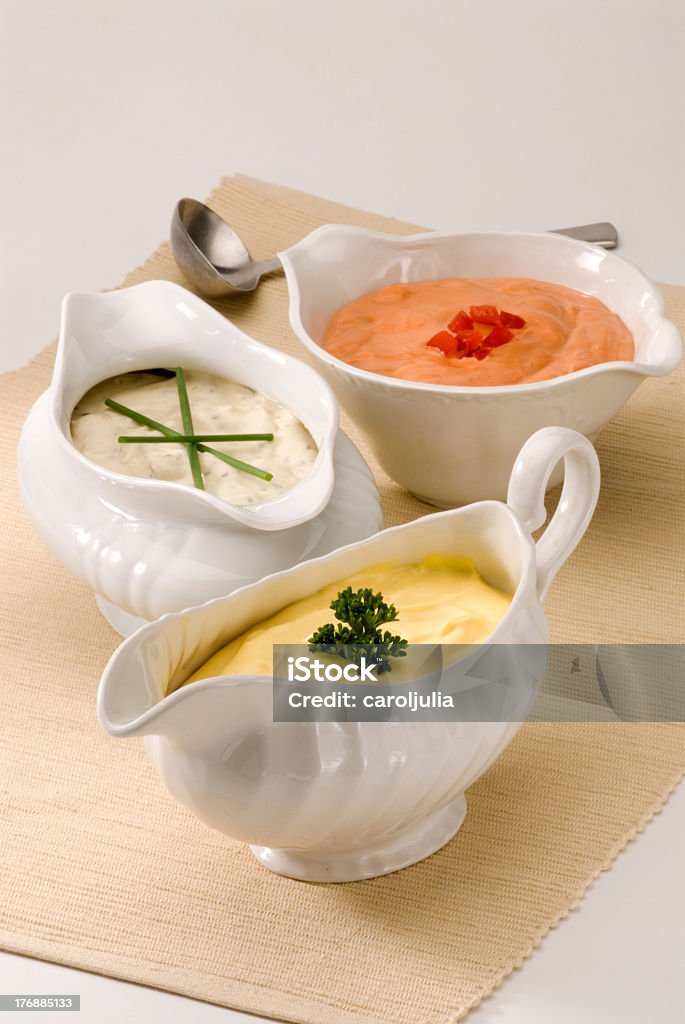 Various bowls of assorted sauces Mayonnaise, cheese and cocktail sauces in sauceboats. Salad dressing. Cheese Dip Stock Photo