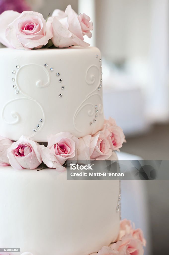 Wedding Cake with Pink Roses White wedding cake with pink roses and diamond pattern. Baking Stock Photo