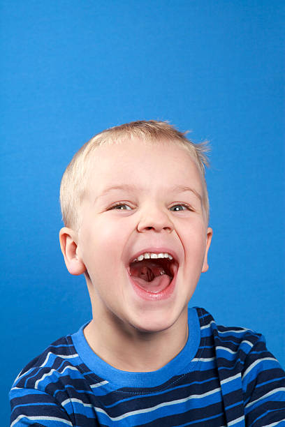 Close-up shot of boy laughing stock photo