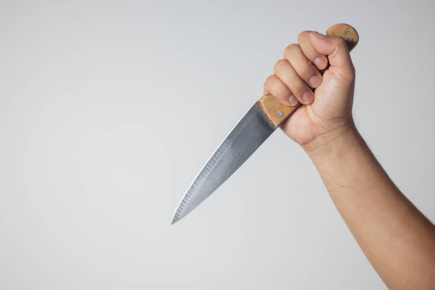 istock Male hand holding a knife on white background 1768854677