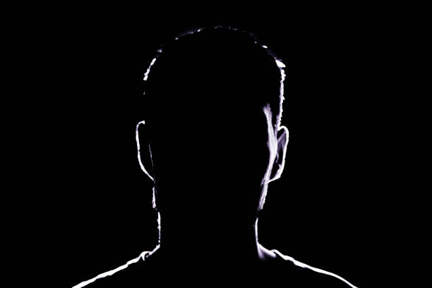 istock dark backlight shadow silhouette of male person, incognito unknown profile 1768858543