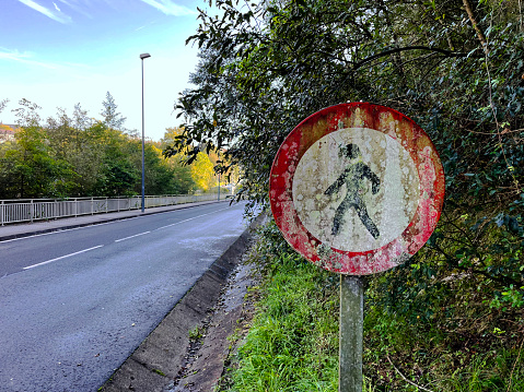 Old dirty pedestrians prohibited road sign