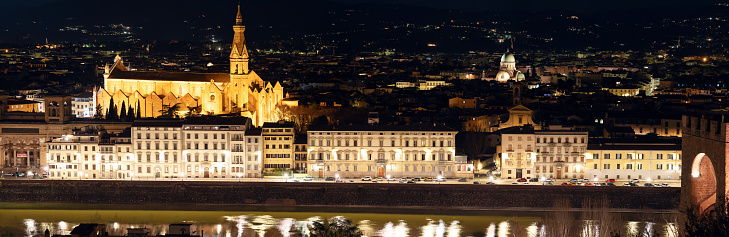 Night panoramic view of Basilica Holy Cross, Sinagogue of Florence and river Arno. Illuminated medieval buildings