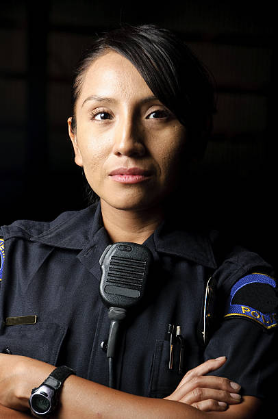 An Uniformed Female Police Officer With Her Arms Folded Stock Photo -  Download Image Now - iStock