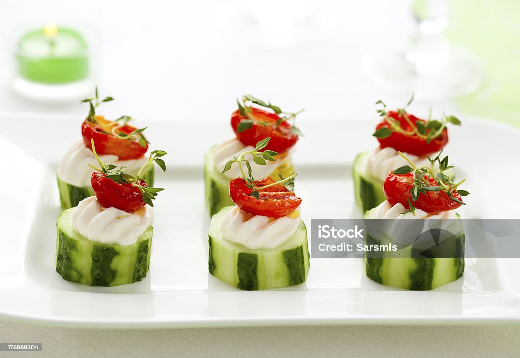 Holiday vegetable appetizer Holiday vegetable appetizer with cucumber, soft cheese and sun dried tomato Appetizer Stock Photo