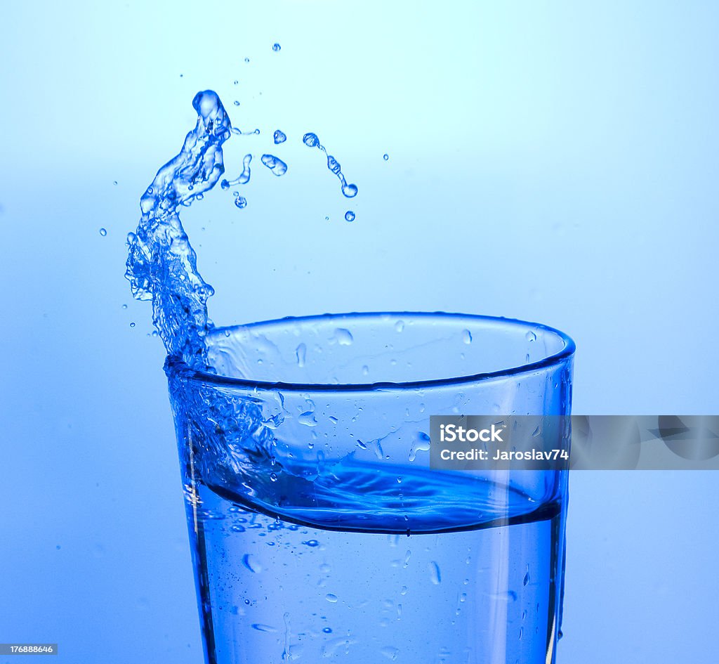 Water Fresh  spray water on blue background. Alcohol - Drink Stock Photo