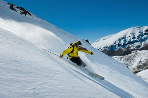 Male Skier Tackling Slippery Mountain Slopes