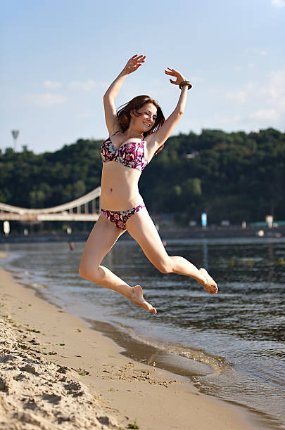 istock Woman jumping on the river beach 176889307