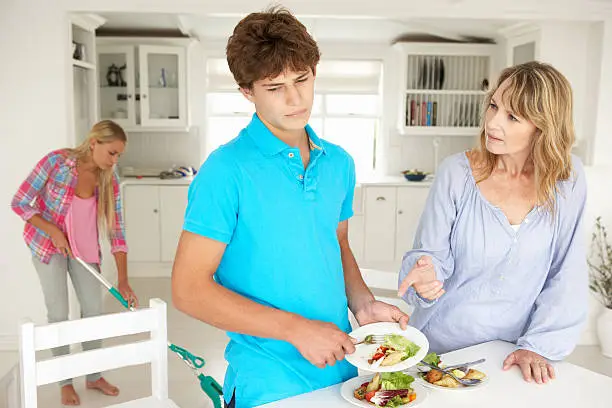 Teenagers reluctant to do housework being scolded by mother