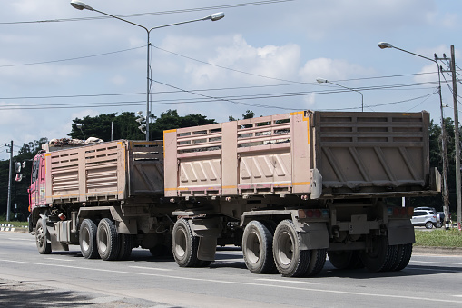 Chiangmai, Thailand -  Auguest  29 2023: Trailer Dump truck of Thanachai Company. On road no.1001, 8 km from Chiangmai city.