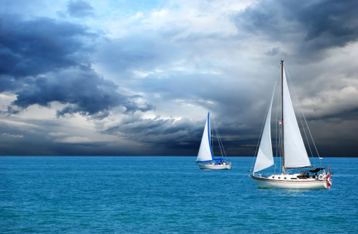 two sailboats sailing after a storm