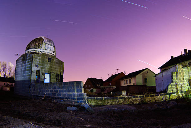 Astronomer connecting photo telescope and computer before night comes in daytime