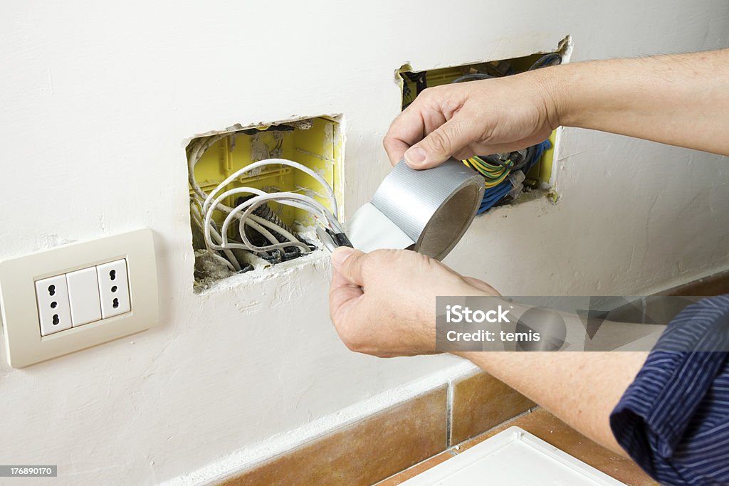 electrician at work lectrician at work in a site Blue-collar Worker Stock Photo