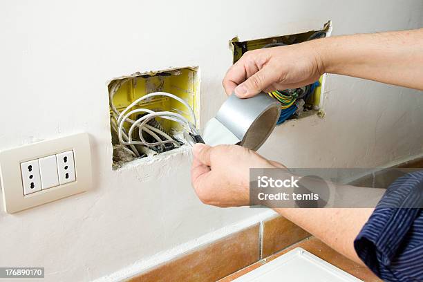 Electrician At Work Stock Photo - Download Image Now - Blue-collar Worker, Cable, Construction Industry