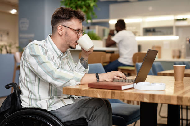 istock Businessman with disability working online in cafe 1768904295