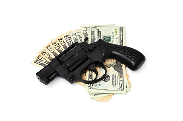 istock revolver and dollars 176890447