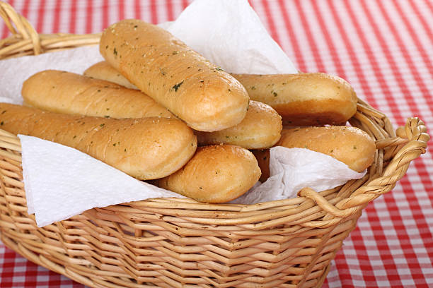Breadsticks Bunch of garlic breadsticks in a basket breadstick stock pictures, royalty-free photos & images