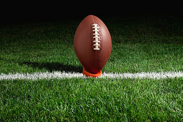 istock Football on tee at night 176890720
