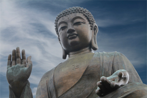 The Tian Tan Buddha in Hong Kong with a background of a dark foreboding sky