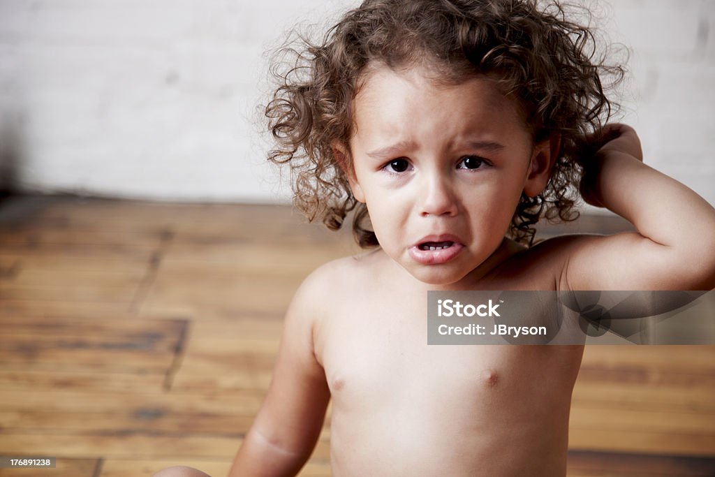 Mixed Race Toddler Girl is Angry and Crying Note: Very shallow depth of field. A mixed race (caucasian and African American) 2 year old girl is angry and holds her hand up as she cries. Toddler Stock Photo