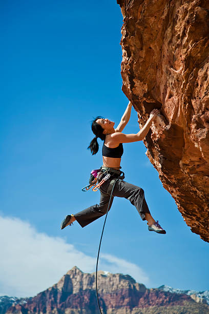 istock Rock climber clinging to a cliff. 176891882